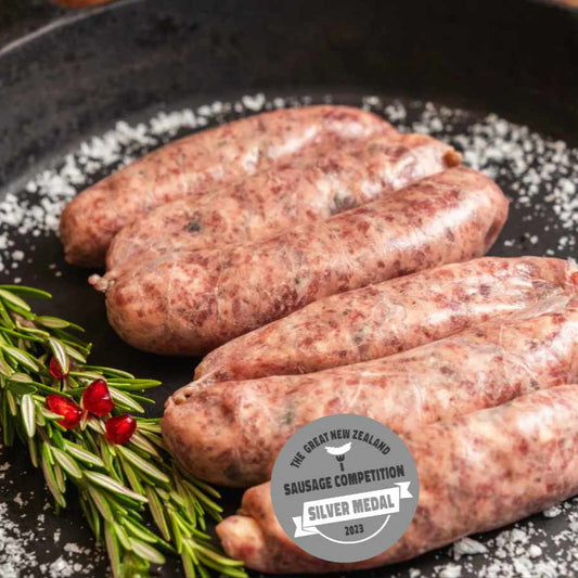 6 pack of gluten free beef brisket, pickle, cheese & pepper sausages – award-winning NZ sausage with grass-fed beef and Aldersons pickles in cast iron pan cooking