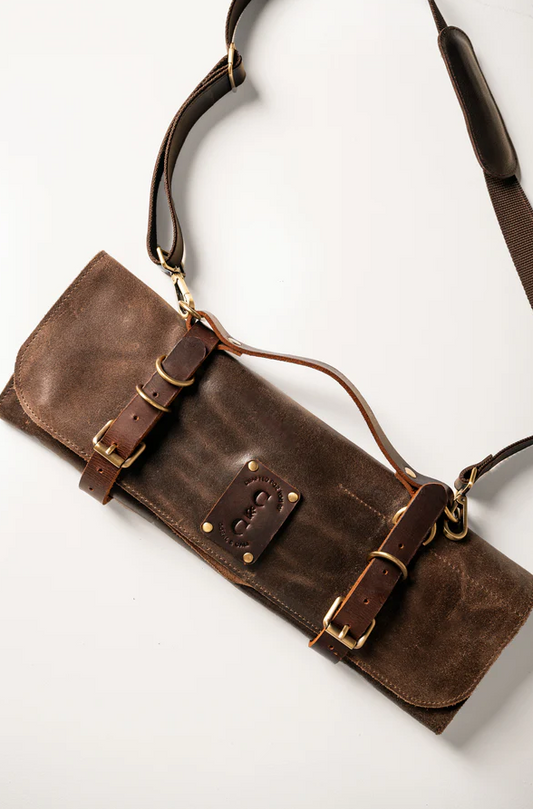 Premium leather knife roll with cotton canvas lining, holds up to six knives, spark-resistant, includes adjustable shoulder strap