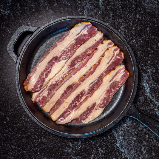 250g pack of NZ beef brisket bacon – grass-fed beef, dry cured and smoked with manuka wood chips cooking cast iron pan